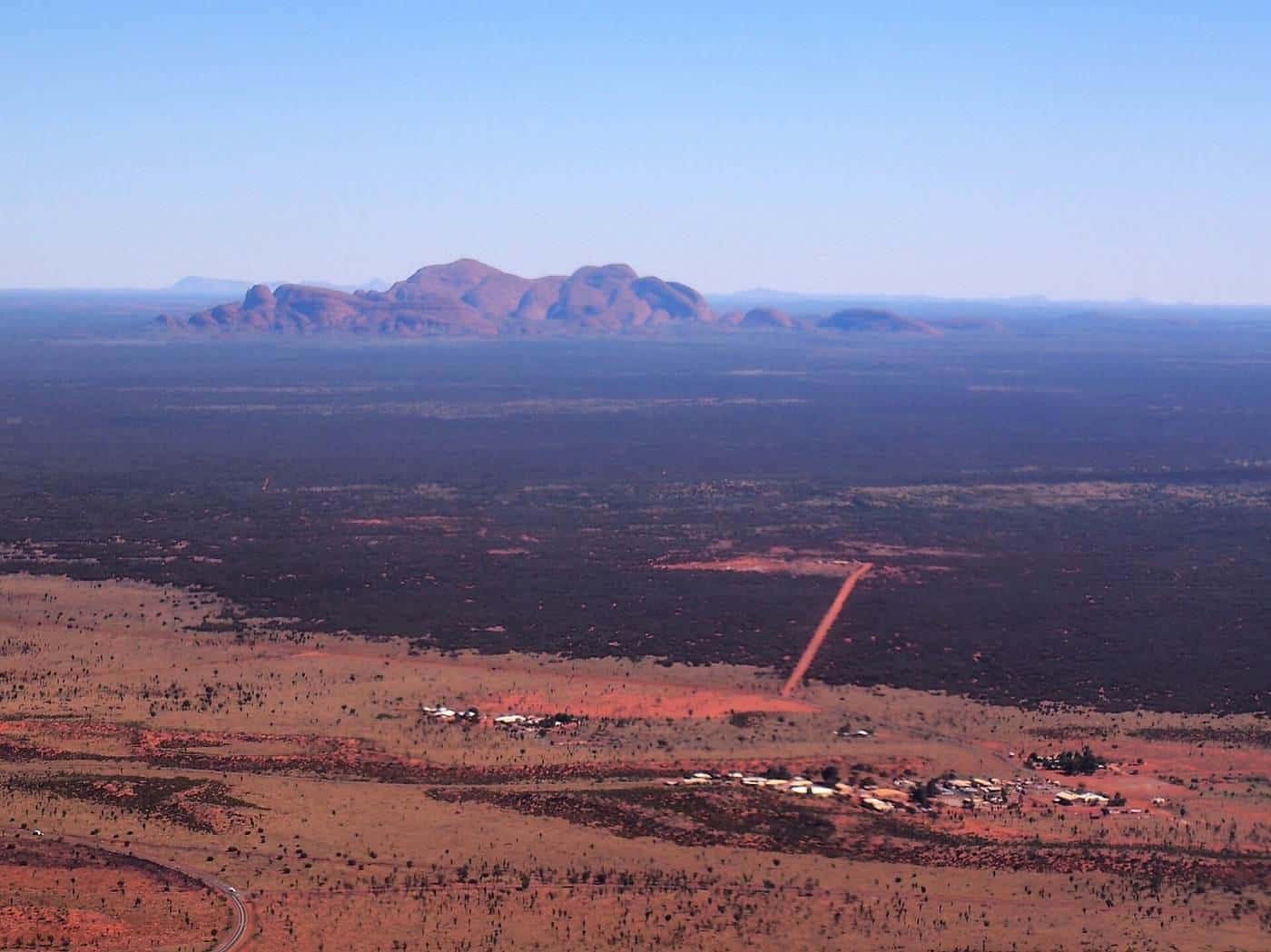 Kata Tjuta on the horizon across red desert
