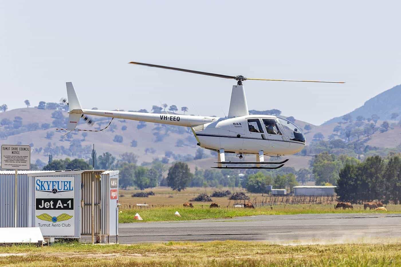 A Robinson R44 helicopter on the ground at a regional airport
